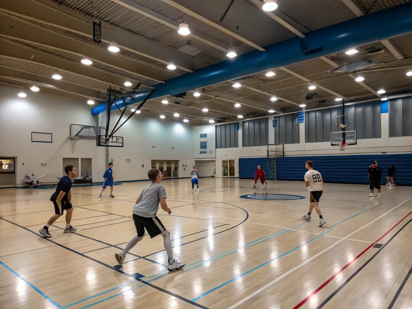 A vibrant image of students playing a friendly game of basketball on an indoor court, showcasing teamwork and sportsmanship.