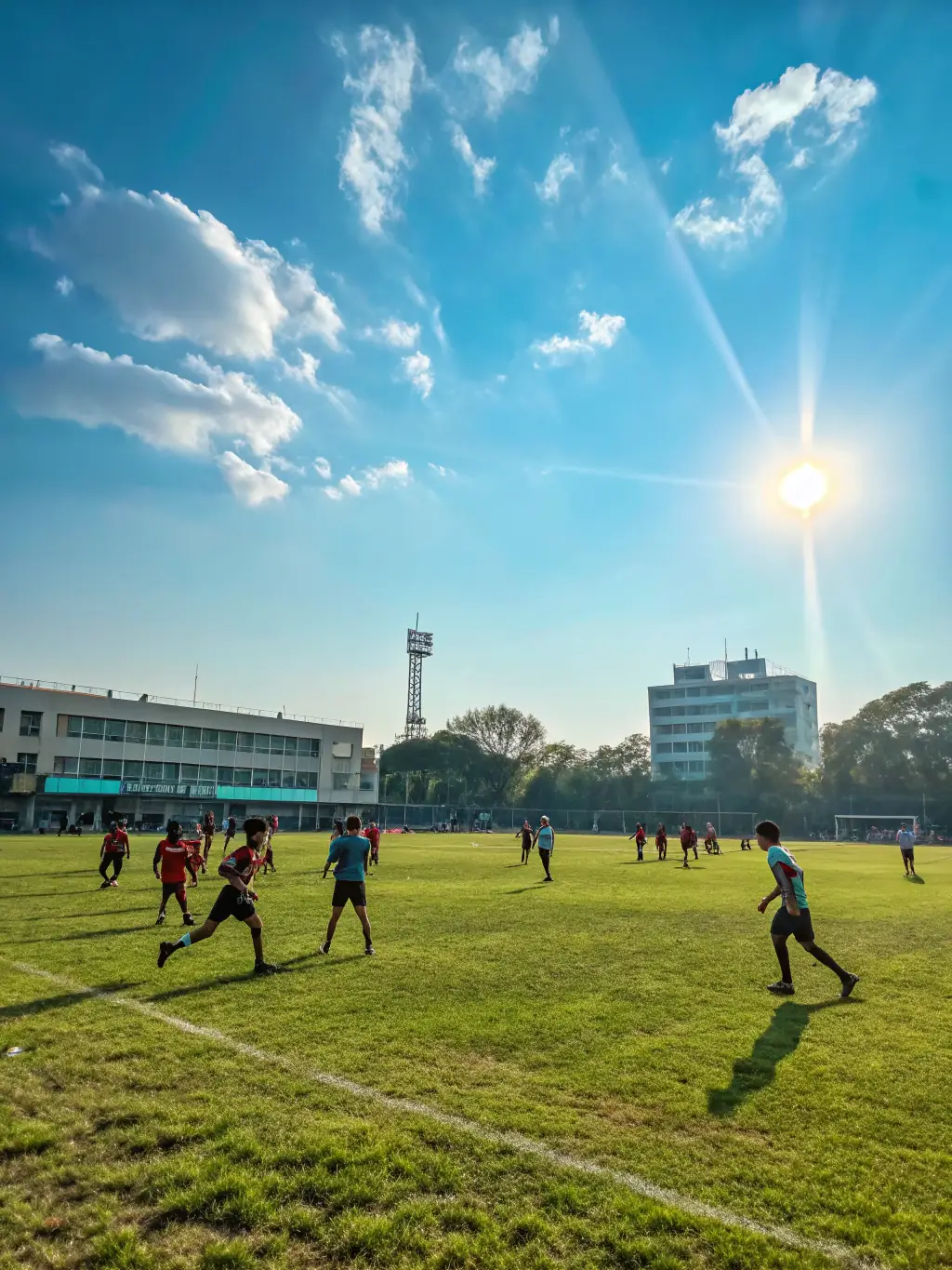 A vibrant image of students participating in a friendly football match on a sunny day, showcasing teamwork and sportsmanship.